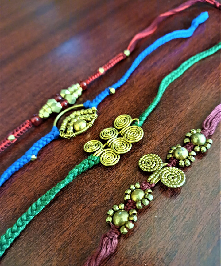 Set of four handmade dhokra brass rakhi with cotton thread