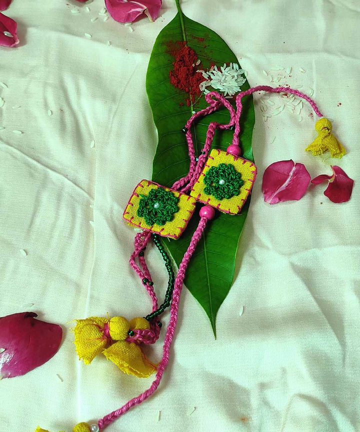 Yellow green handmade thread work upcycled fabric rakhi