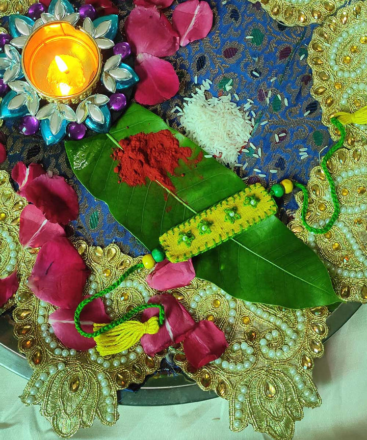 Yellow green handcrafted thread work upcycled fabric rakhi