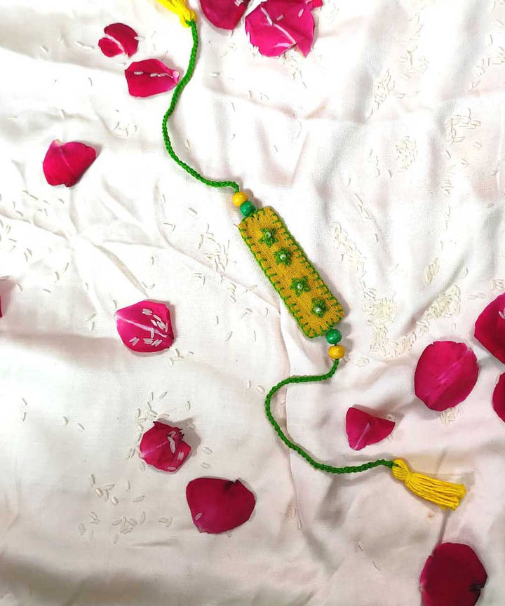 Yellow green handcrafted thread work upcycled fabric rakhi