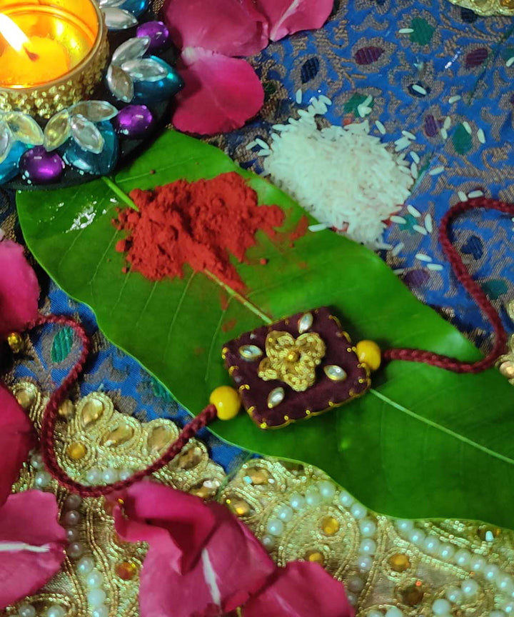 Maroon yellow hand crafted thread work upcycled fabric rakhi