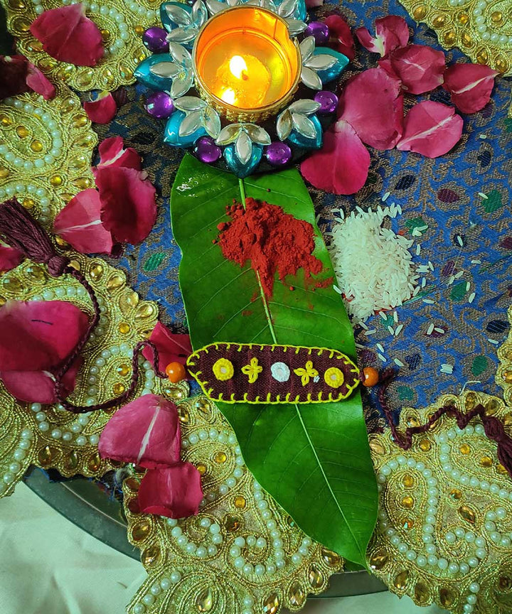 Maroon yellow handcrafted thread work upcycled fabric rakhi