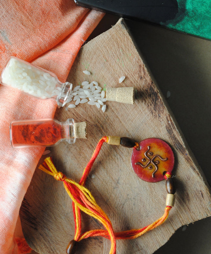 Orange handcrafted enamelling copper rakhi