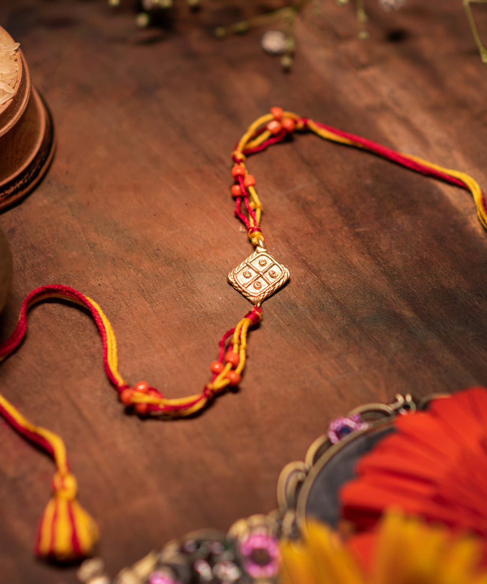 Handcrafted dhokra rakhi with multicolor mercerised cotton thread