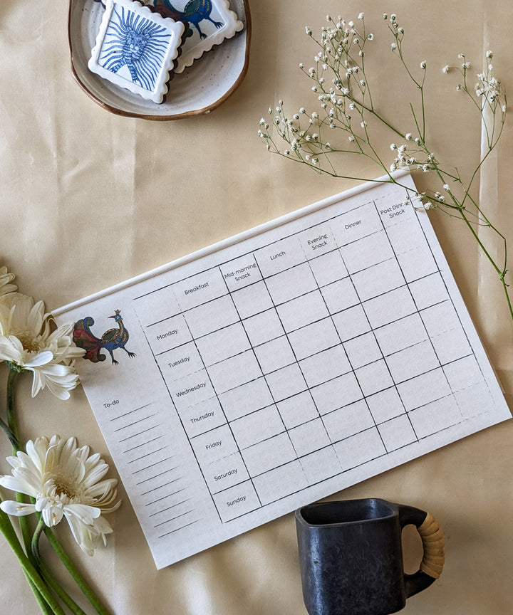 White handcrafted gond art kitchen menu planner