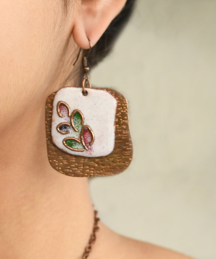 White golden handcrafted leaf motif copper enamel earrings