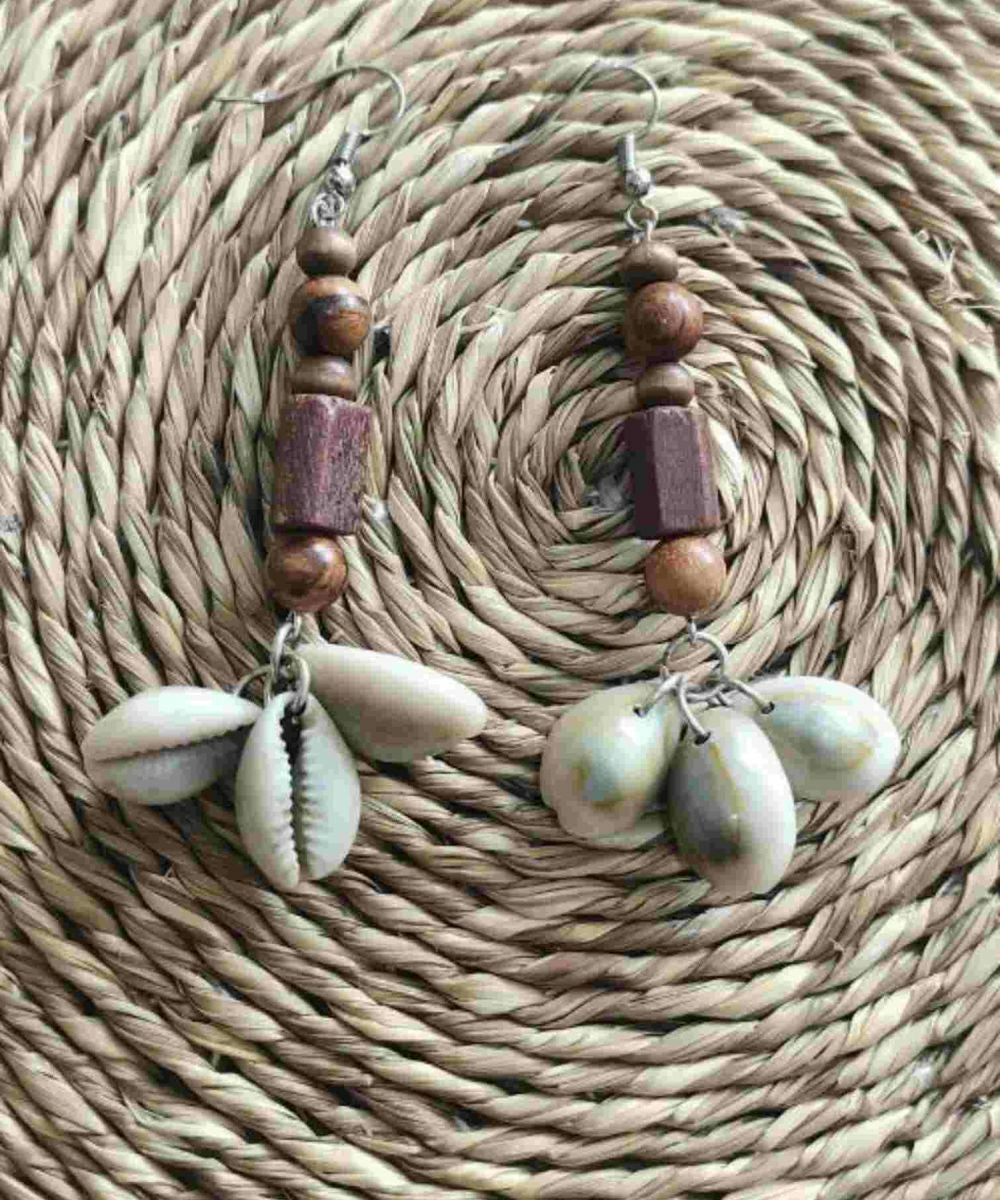Brown handmade dangler earrings with wooden beads and cowry shells