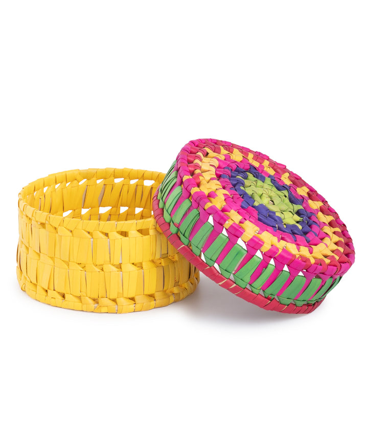 Handwoven colorful round palm leaf basket