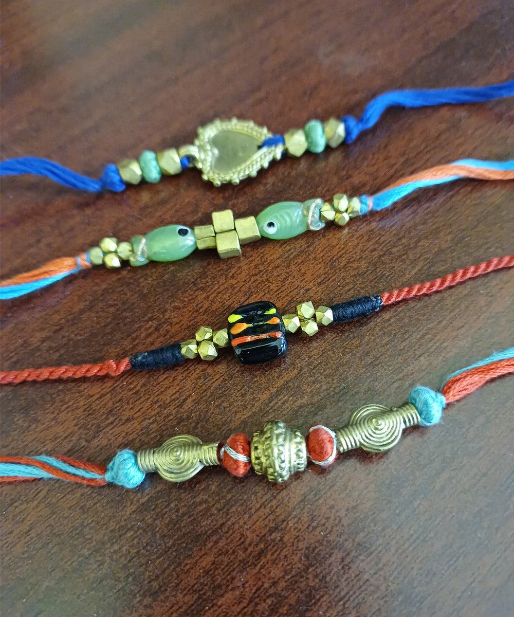 Set of four hand crafted dhokra rakhi with cotton thread