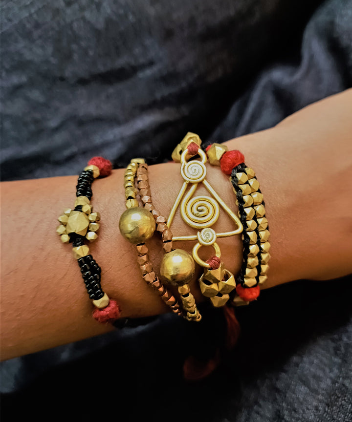 Set of four handcrafted dhokra brass rakhi with cotton thread