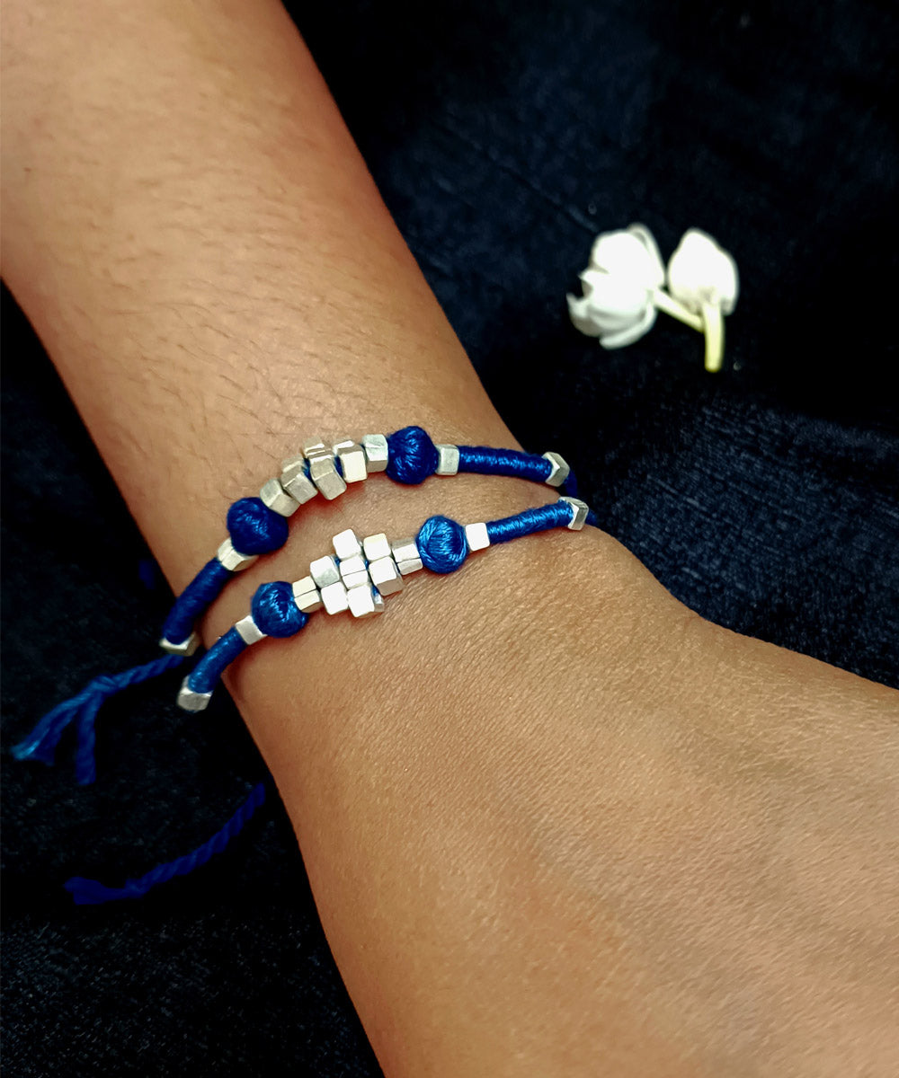 Set of four handcrafted silver rakhi with cotton thread