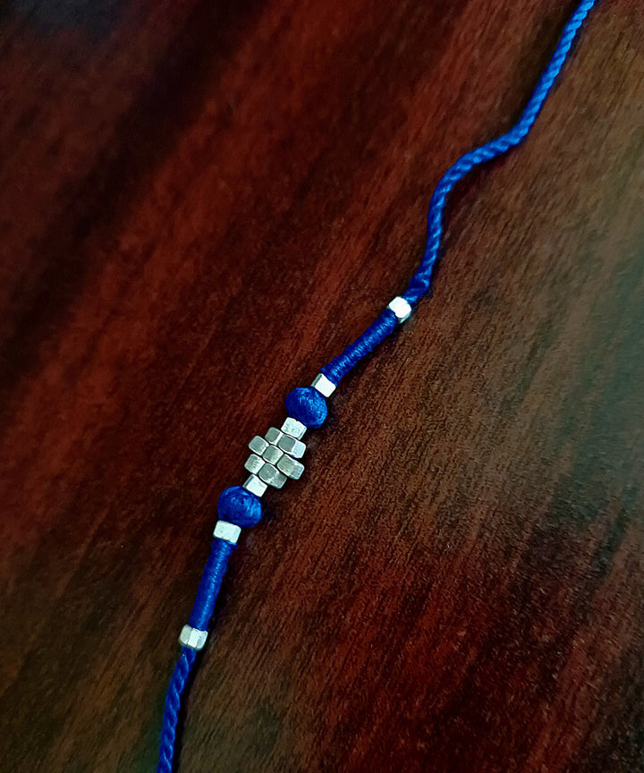 Set of four handcrafted silver rakhi with cotton thread