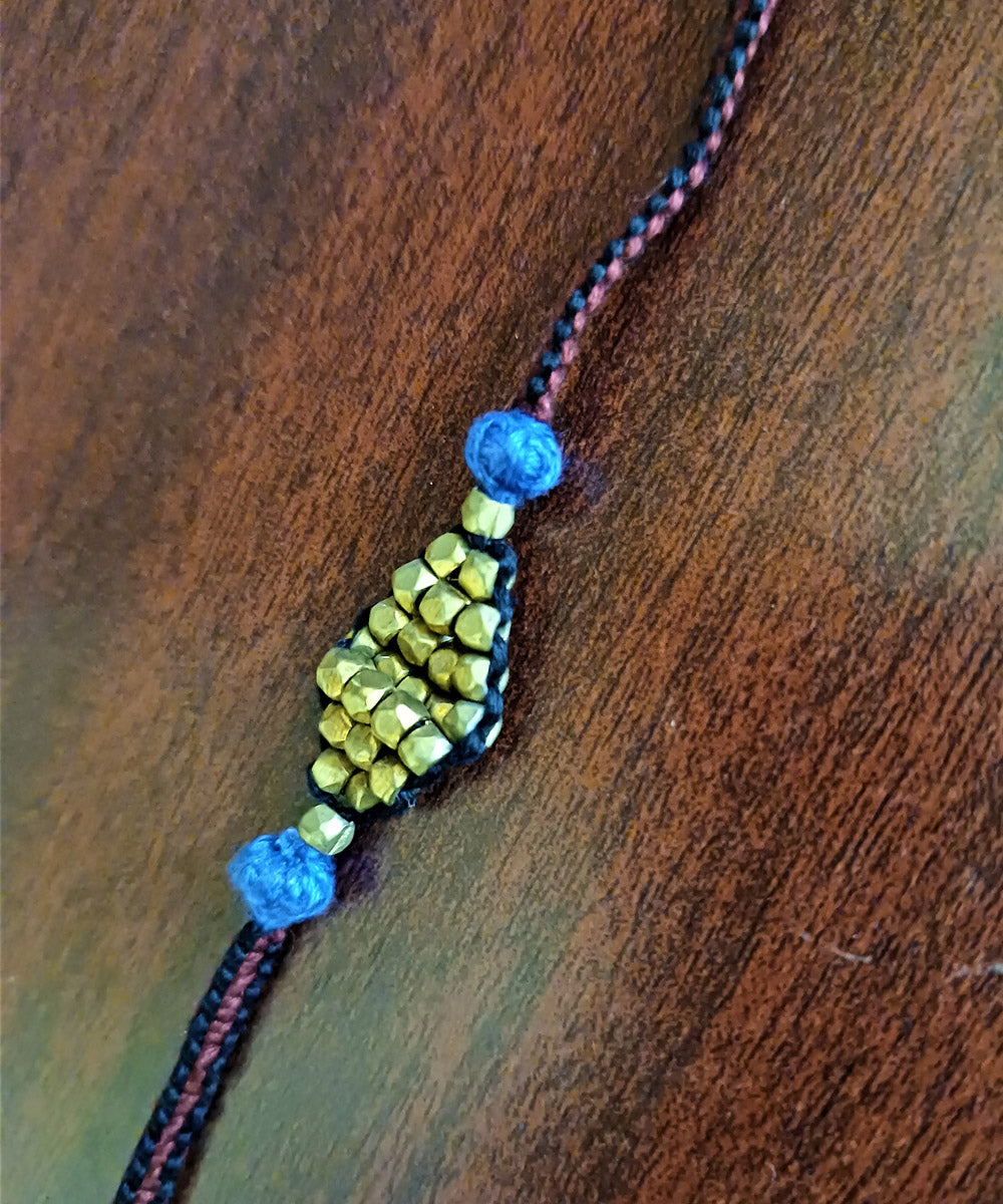 Hand crafted set of four dhokra brass rakhi with cotton thread