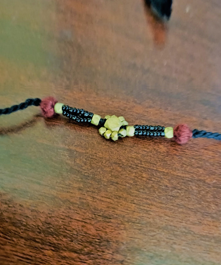 Set of four handcrafted dhokra brass rakhi with cotton thread