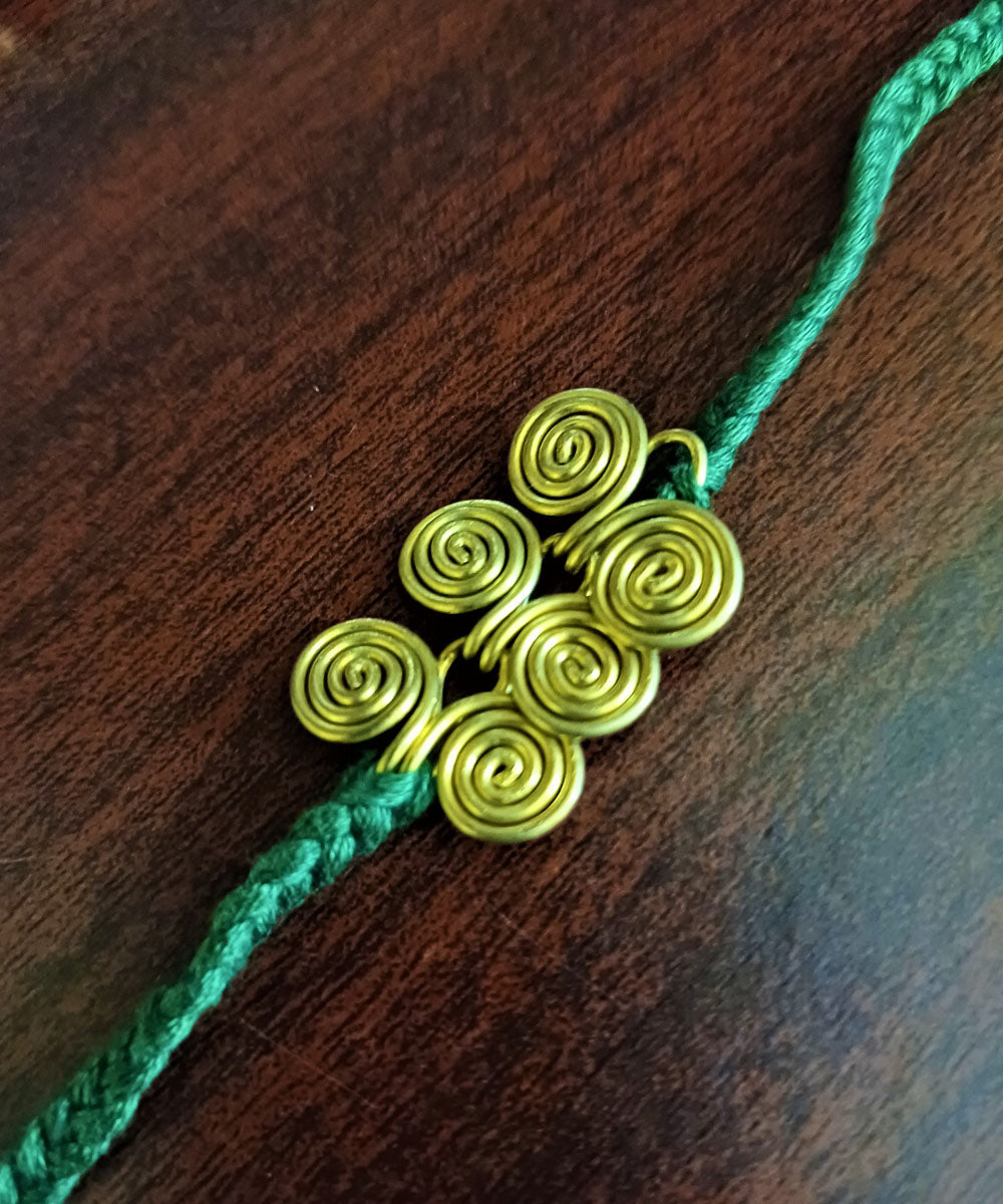 Set of four handmade dhokra brass rakhi with cotton thread