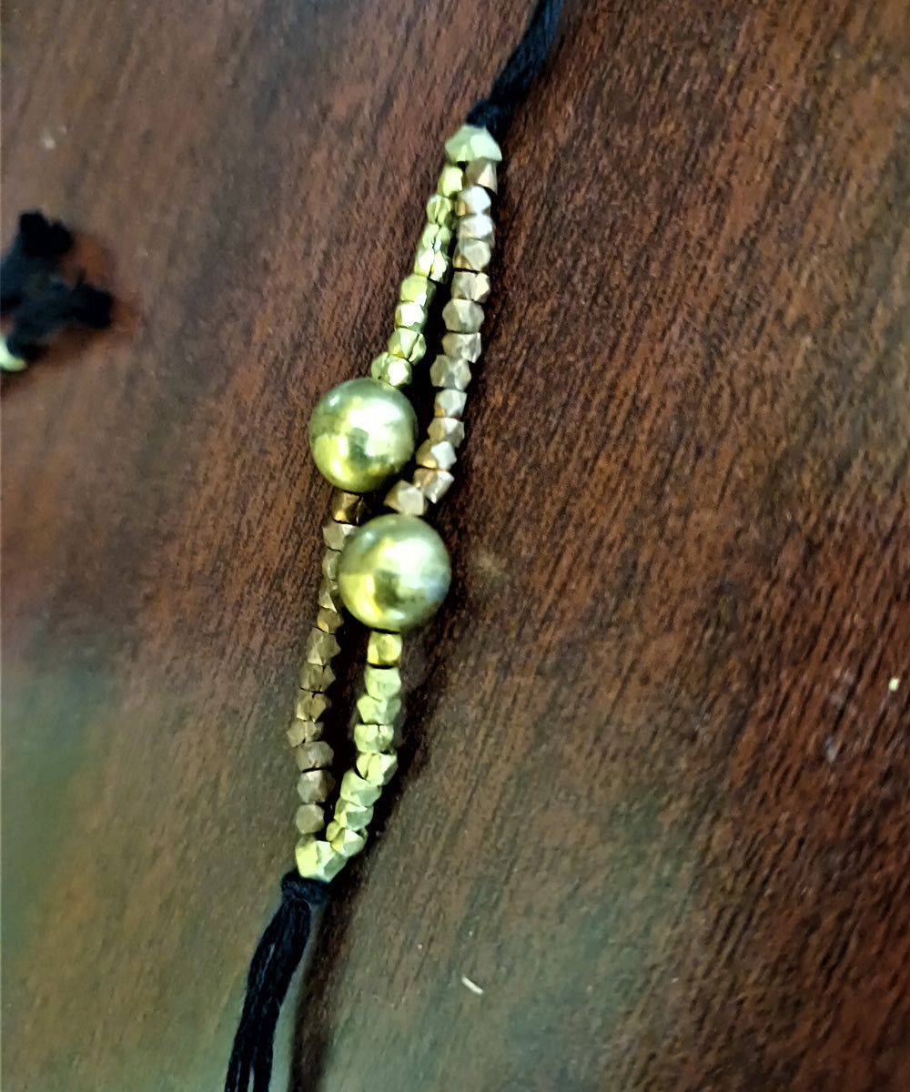Set of four handcrafted dhokra brass rakhi with cotton thread