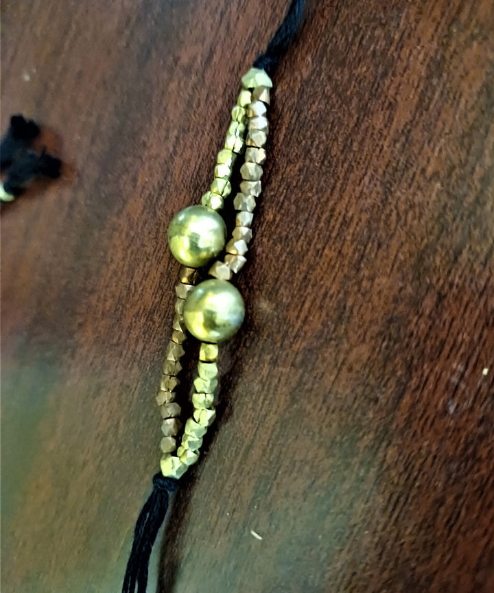 Set of four handcrafted dhokra brass rakhi with cotton thread
