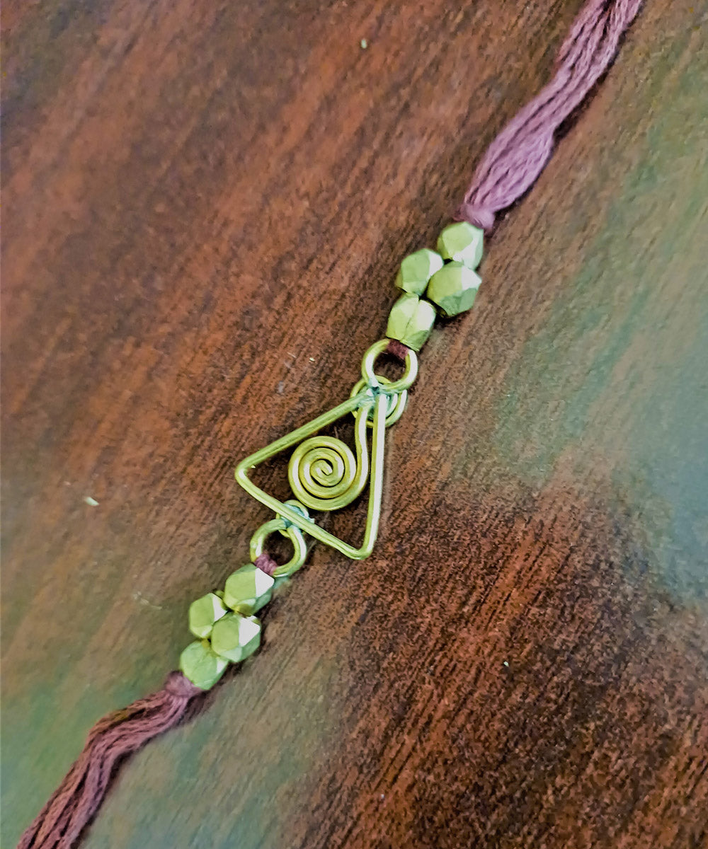 Set of four handcrafted dhokra brass rakhi with cotton thread