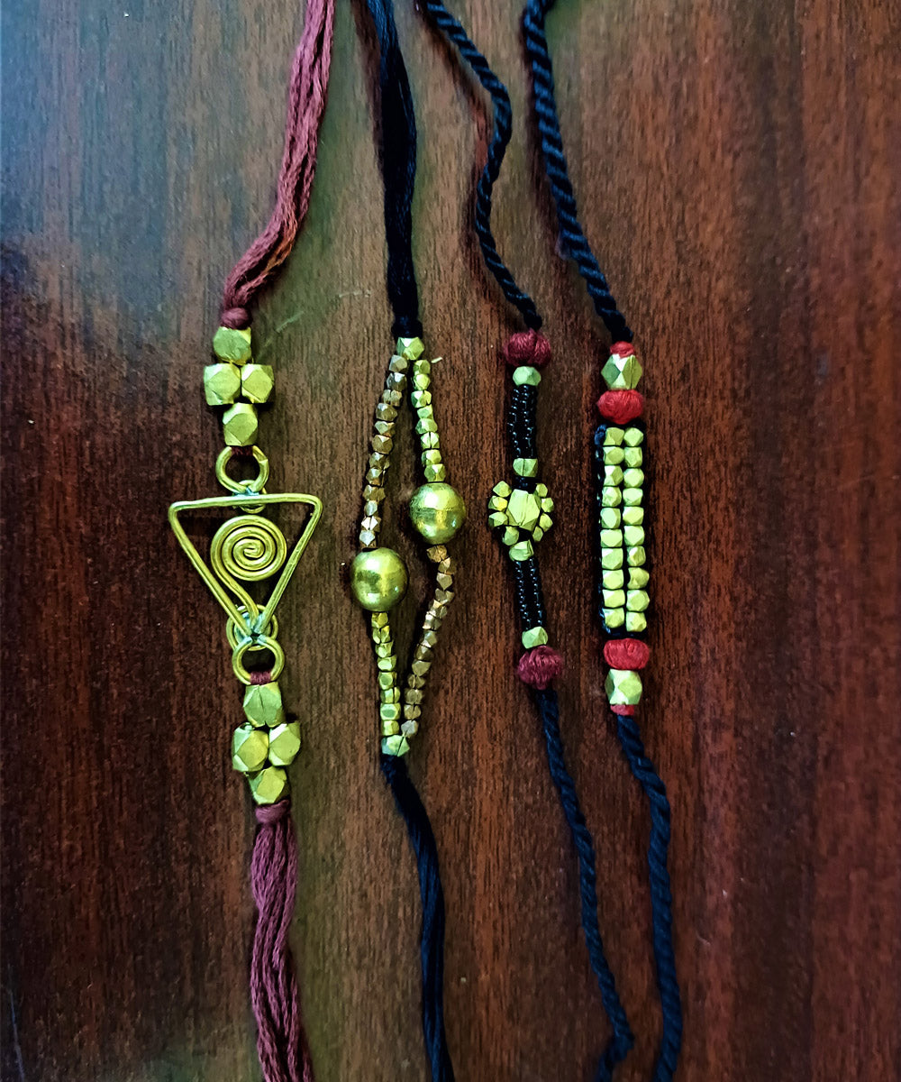 Set of four handcrafted dhokra brass rakhi with cotton thread