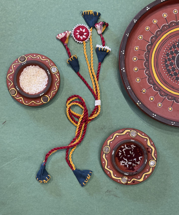 Red yellow blue handmade beads fabric mirror anchor threads rakhi