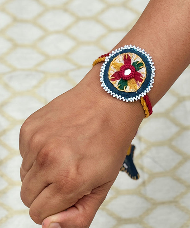 Red yellow blue handmade bead work fabric mirror anchor threads rakhi