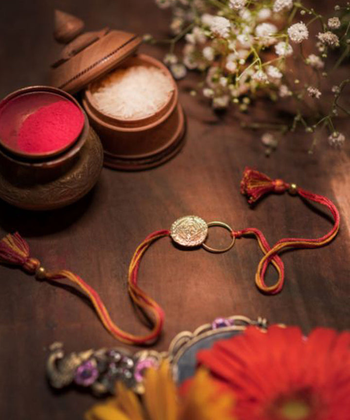 Orange thread crafted rakhi