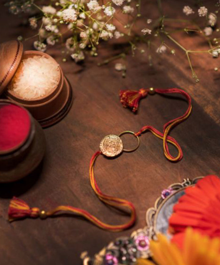 Orange thread crafted rakhi
