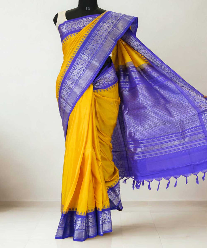 Mustard yellow gadwal silk saree with blue temple border