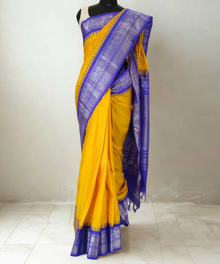 Mustard yellow gadwal silk saree with blue temple border