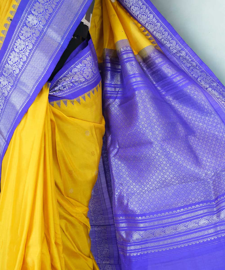 Mustard yellow gadwal silk saree with blue temple border
