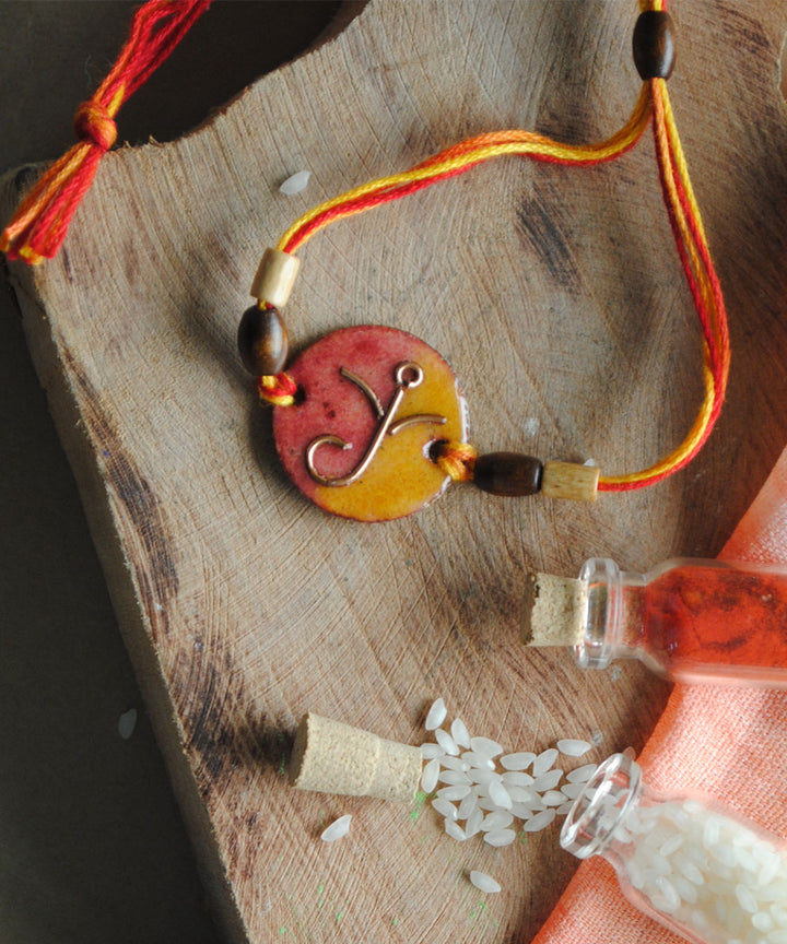Yellow orange handcrafted copper enamelling rakhi