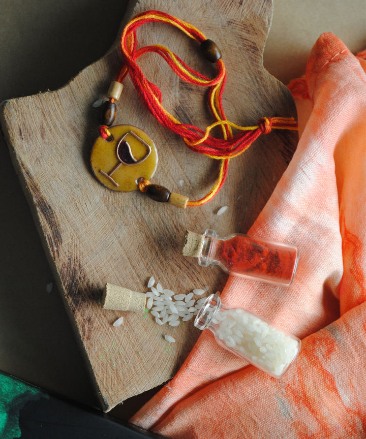 Yellow orange handmade enamelling rakhi