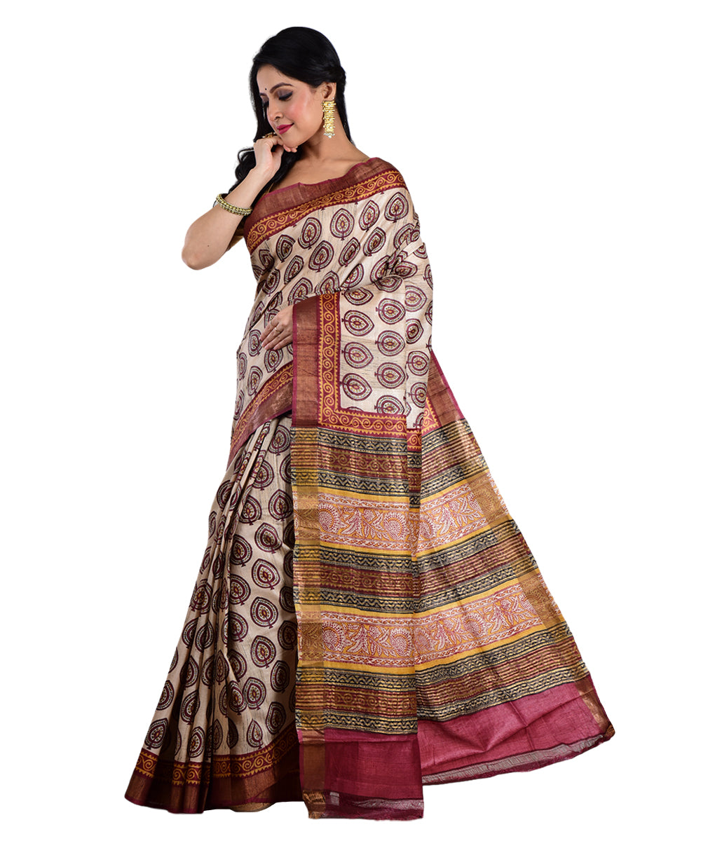 Beige maroon hand printed tussar silk saree