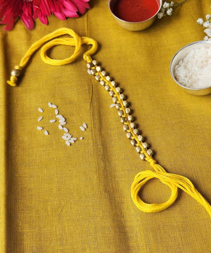 Handcrafted yellow beaded mercerised cotton rakhi