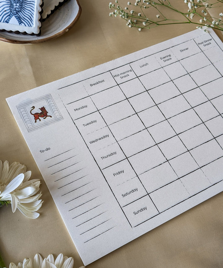 White handcrafted gond art kitchen menu planner