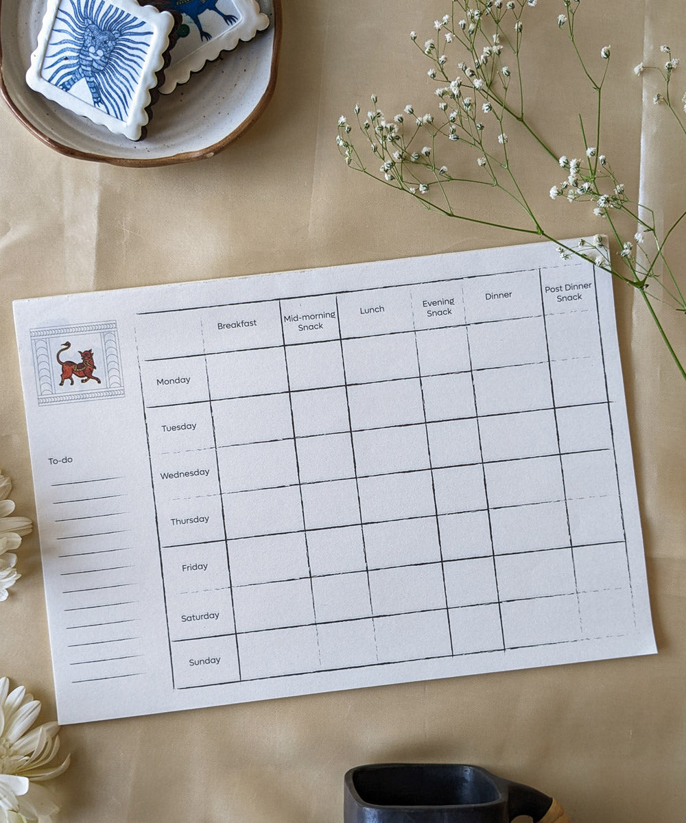 White handcrafted gond art kitchen menu planner