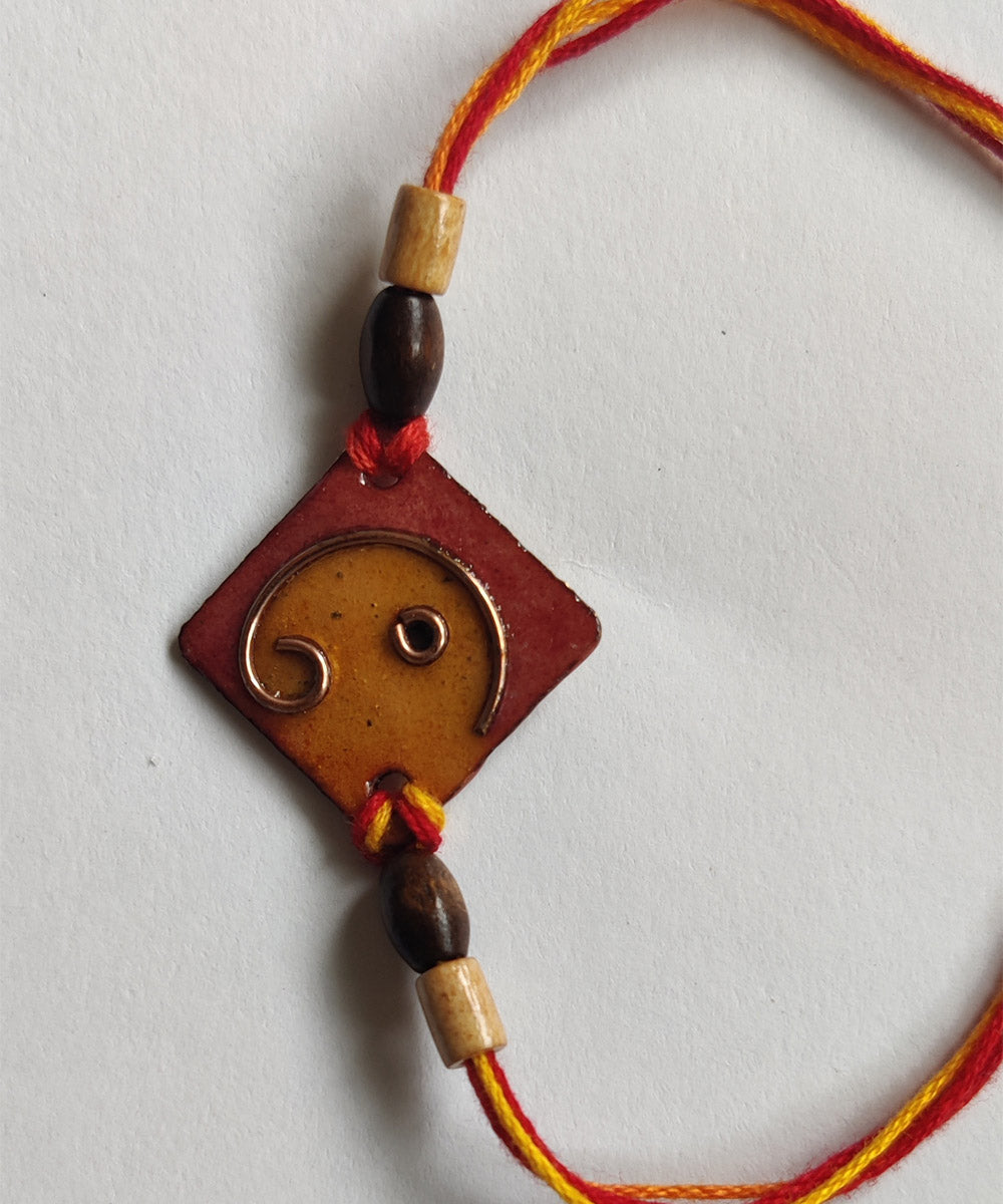 Yellow orange handcrafted copper enamel rakhi