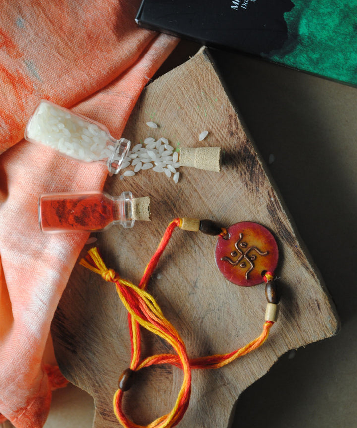Orange hand crafted copper enamel rakhi