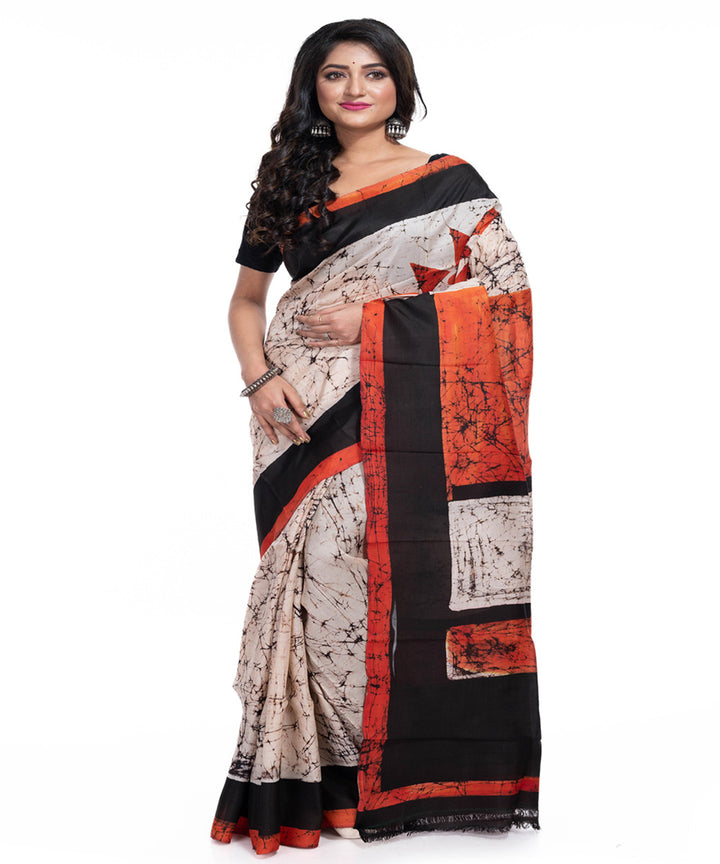 Cream black orange silk handwoven batik print saree