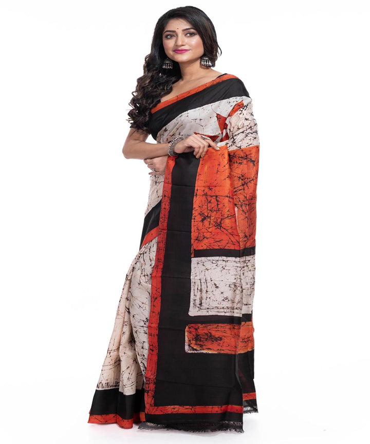 Cream black orange silk handwoven batik print saree