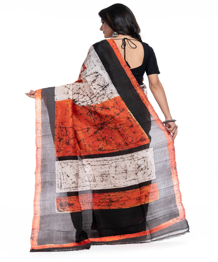 Cream black orange silk handwoven batik print saree