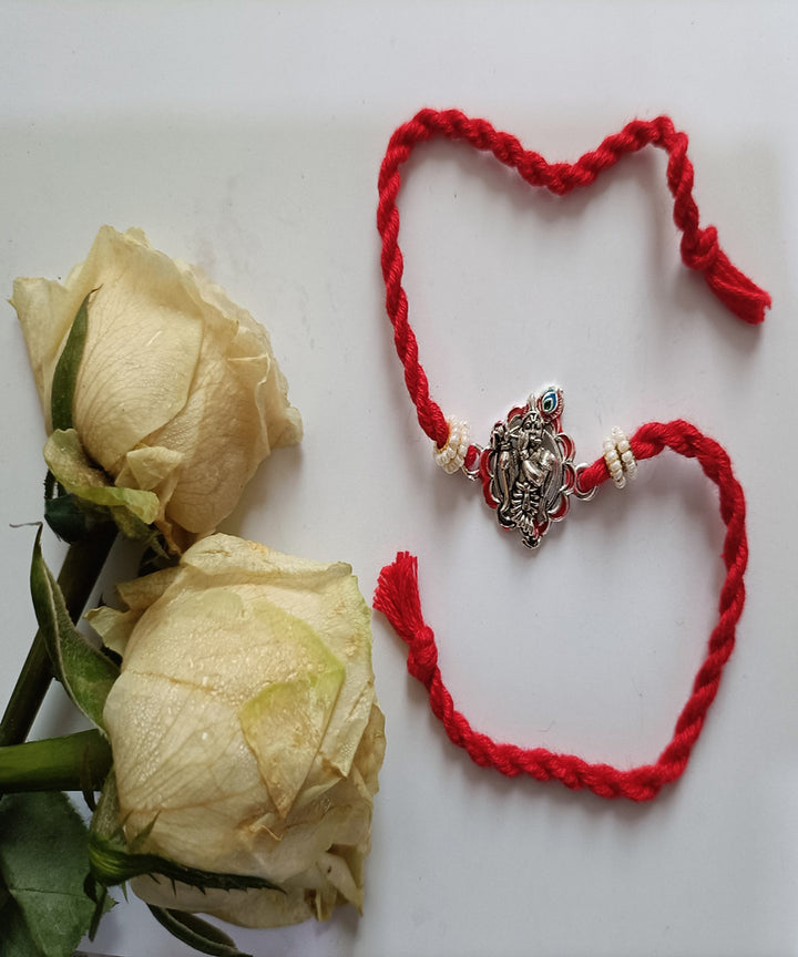 Handmade red metal blessing woolen rakhi