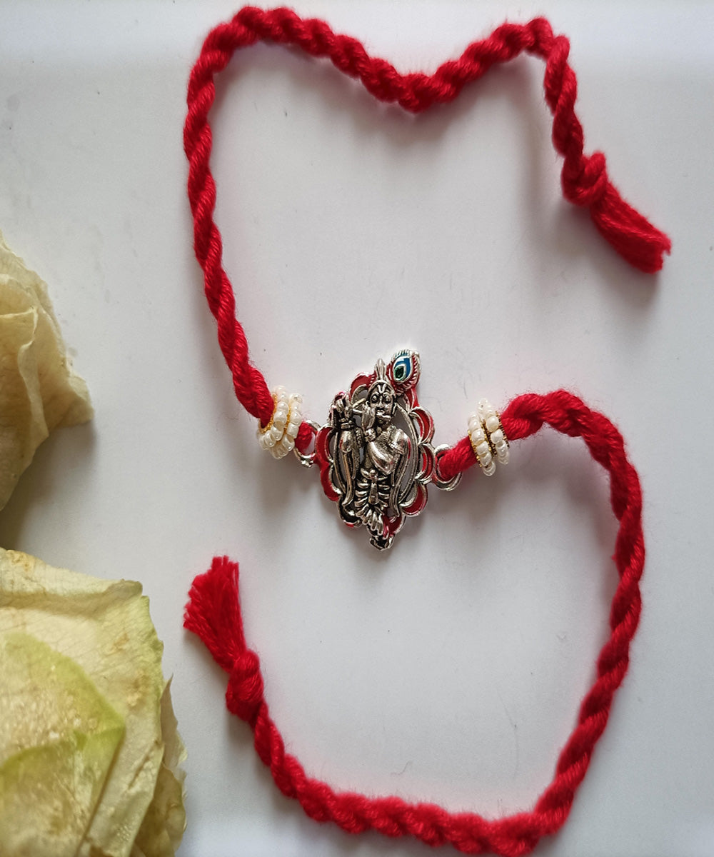 Handmade red metal blessing woolen rakhi