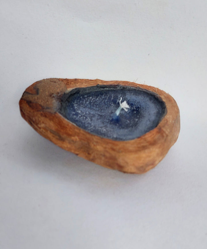 Blue handcrafted flat coconut shell candle