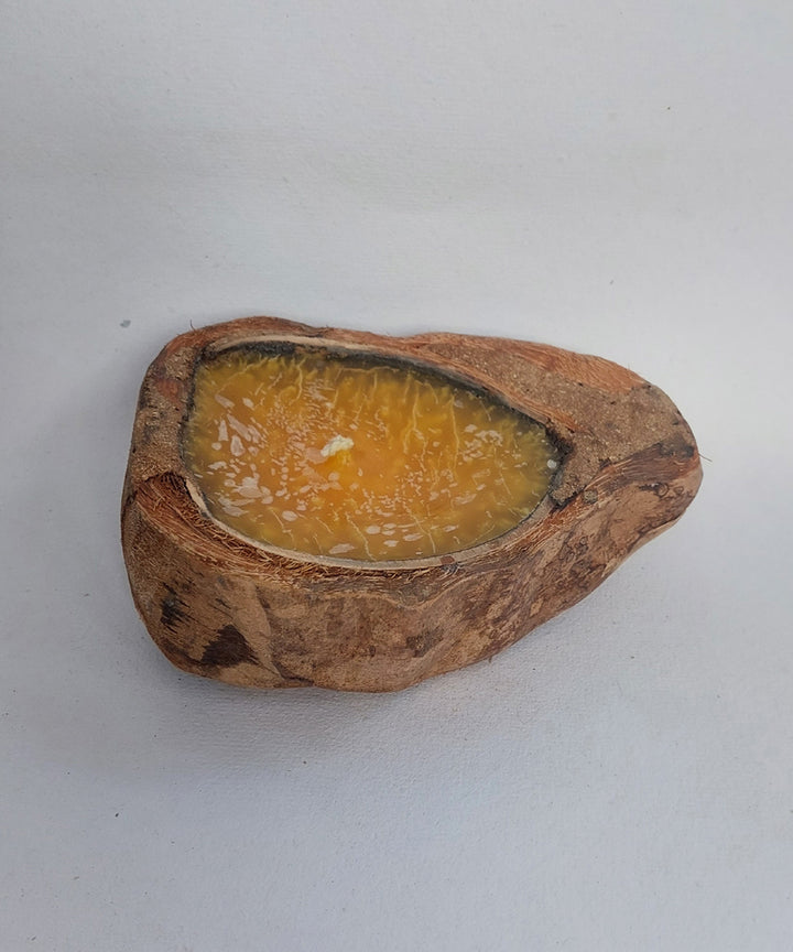 Yellow handcrafted flat coconut shell candle