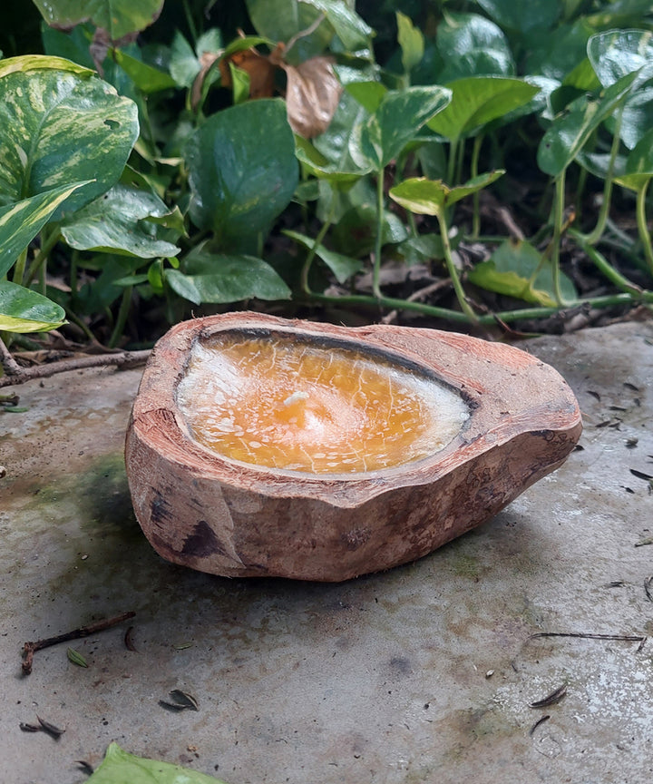 Yellow handcrafted flat coconut shell candle