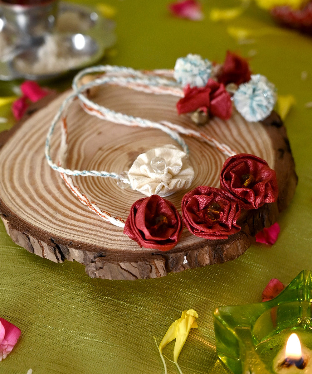 Handcrafted red cream silk rakhi