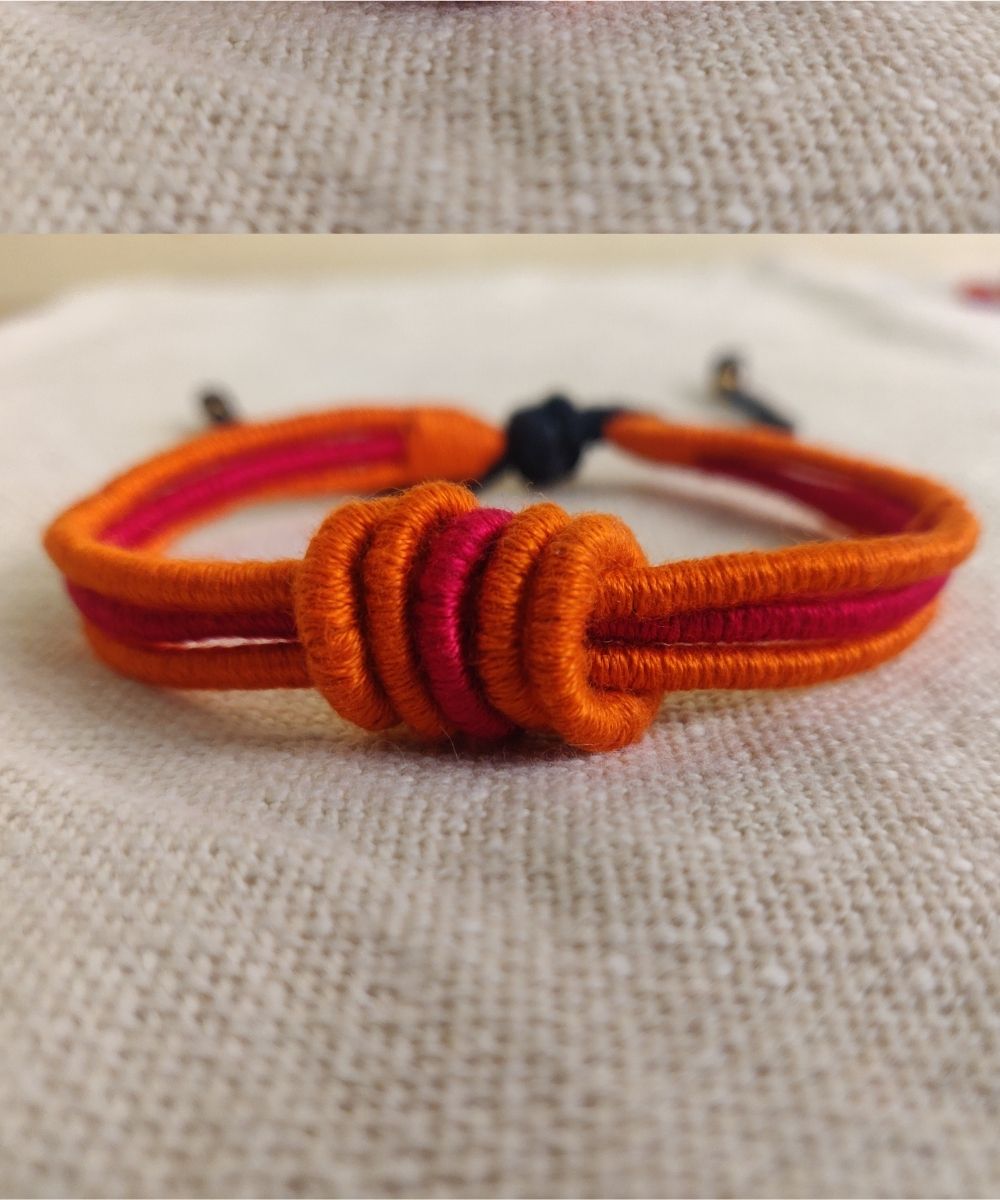Handcrafted orange red rakhi with mercerised cotton thread