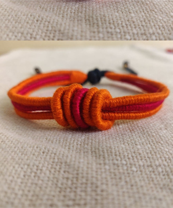 Handcrafted orange red rakhi with mercerised cotton thread