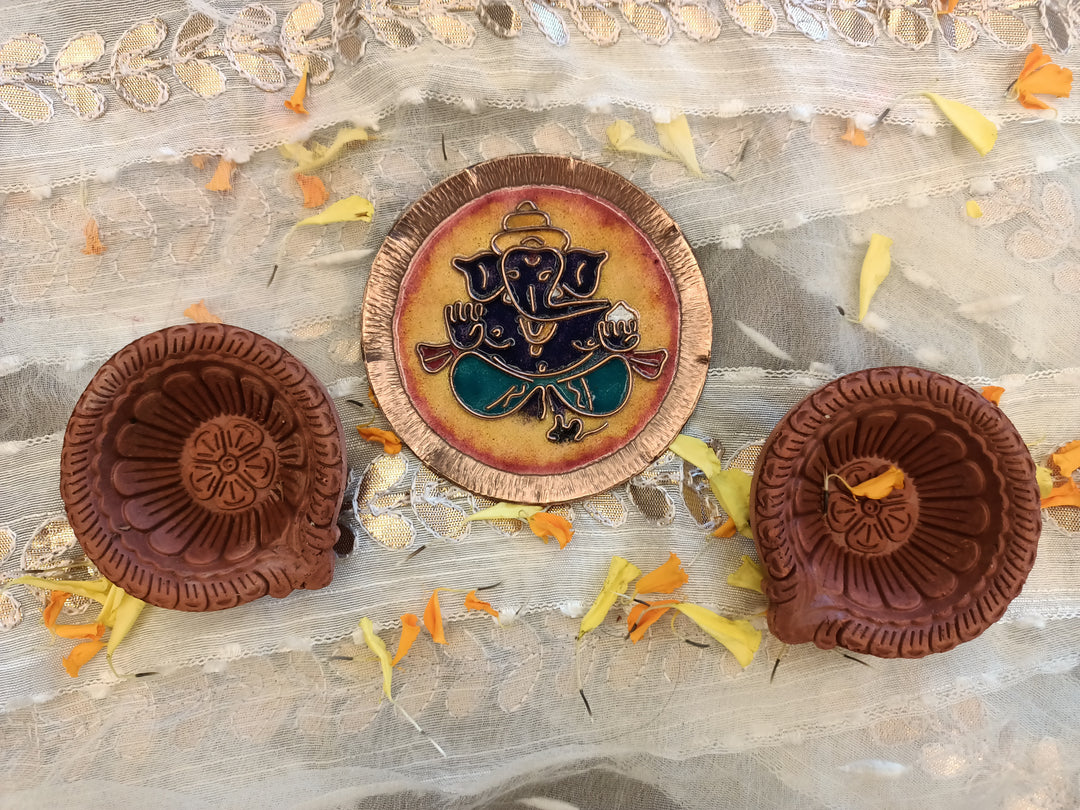 Yellow handcrafted ganesh copper plate and terracotta diya set